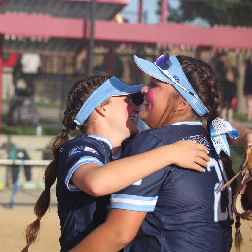 Riverdale Ridge's Sydnee Fordham, left, and Kyla Humphries celebrate the Ravens' first trip to the state softball semifinals Oct. 21 at Aurora Sports Park.
